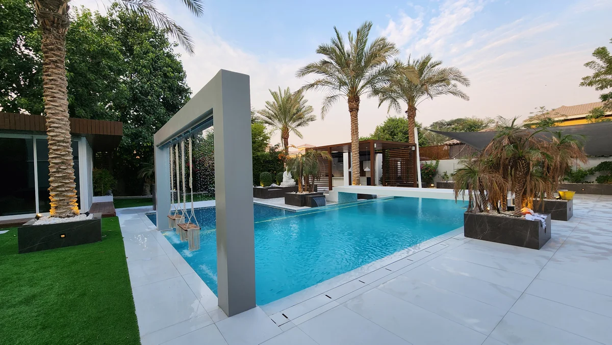 Project Casa Colonia at The Villa: swimming pool framed by planting and an overhead feature