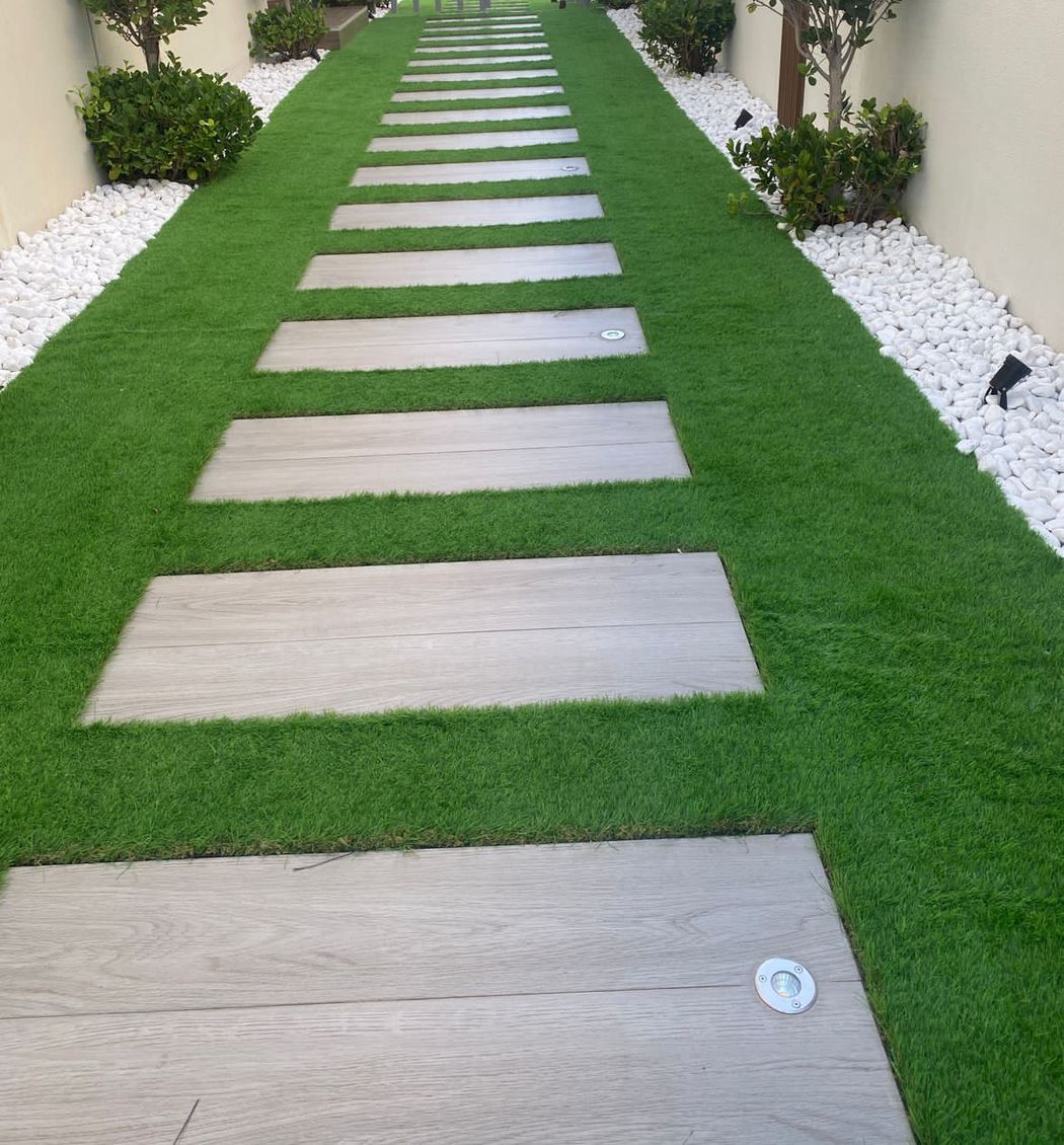 Stepping-stone path through artificial grass between clipped topiary, Project Alpha, Damac Hills 2