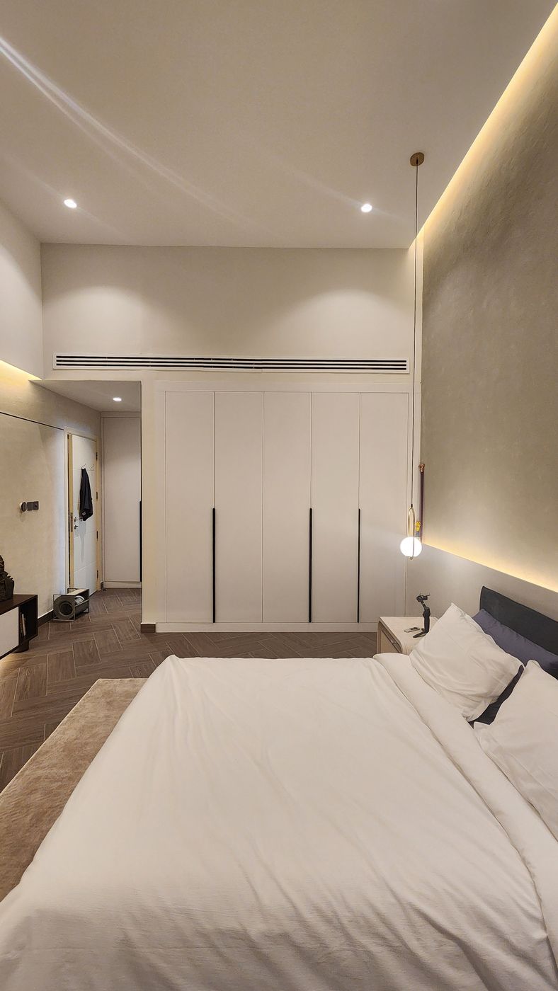 Wall-to-wall built-in wardrobe below a linear AC grille, Project Beyond, Dubai Land, Dubai
