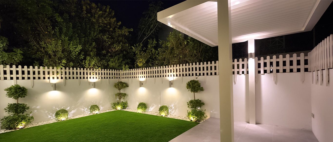 Lawn with planters and lights on the garden side of a fenced wall, Project Mudon, Mudon