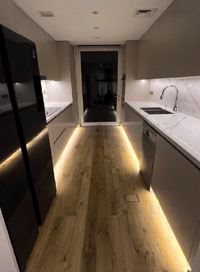 Galley kitchen with handleless units and plinth lighting, Project Mudon, Arabella, Mudon