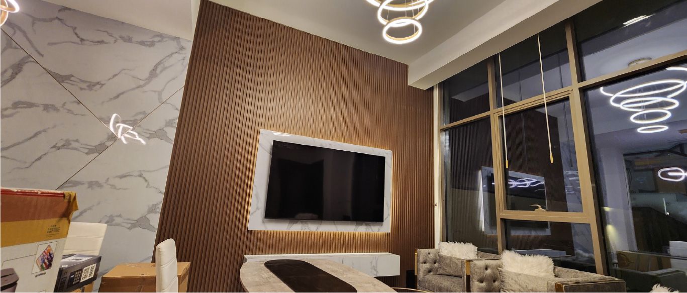 Living room with a slatted timber TV wall and a marble-effect feature wall, Project Murano, Al Furjan