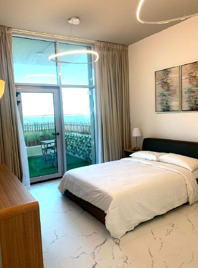 Bedroom with a glazed balcony door and city view, Project Wonder